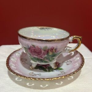 An elegant and beautiful hand painted pink rose tea cup and and saucer.